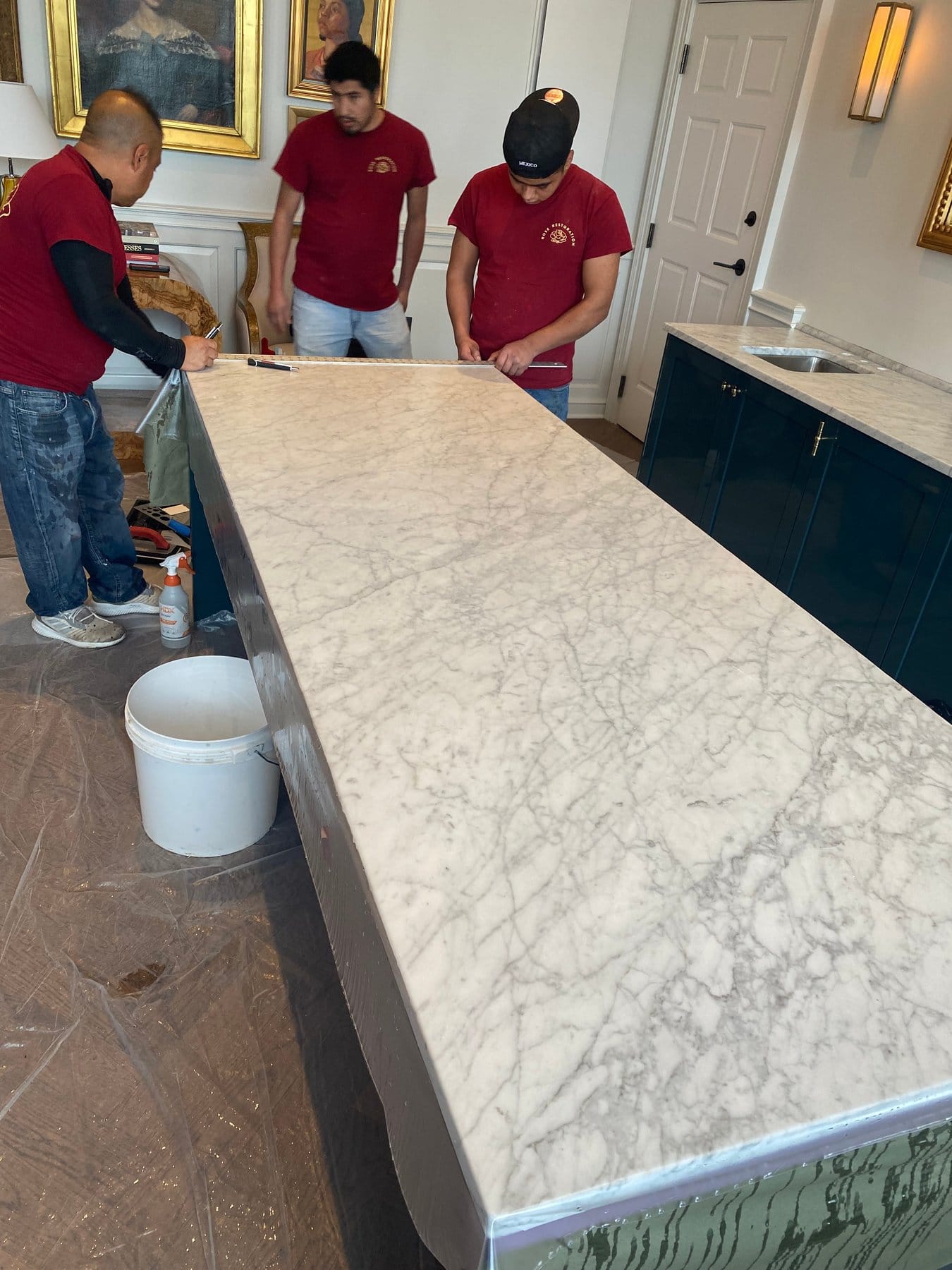 Rose crew finishing a Marble Armor install on a marble island
