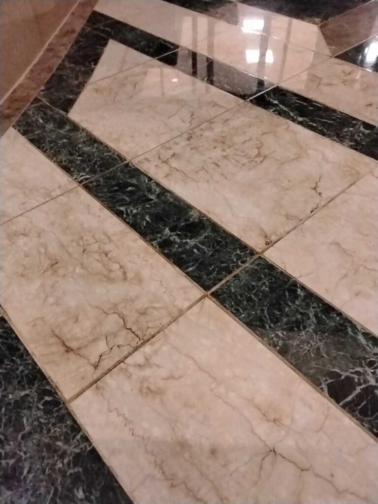 Before: inlaid stone atrium floor in Washington, DC, photographed by Rose Restoration before the work