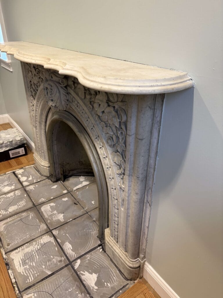 Stone fireplace mantel with carved details from a Rose job in Washington, DC