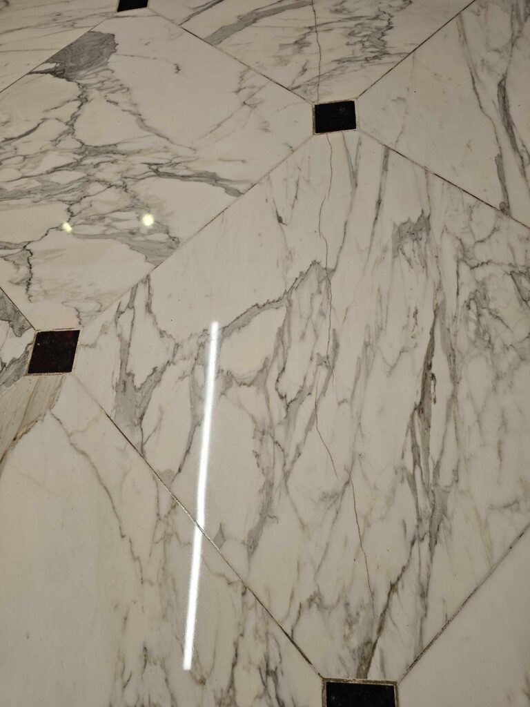 After: the same stone floor with black inserts in Washington, DC after Rose Restoration's work