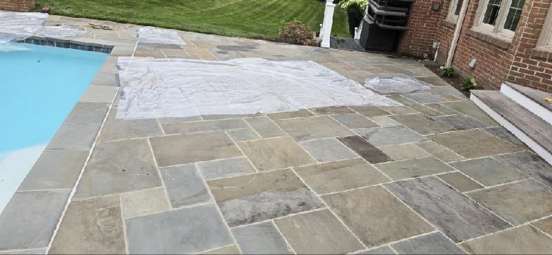 Stone patio with poolside area from a Rose job in Oakton, VA
