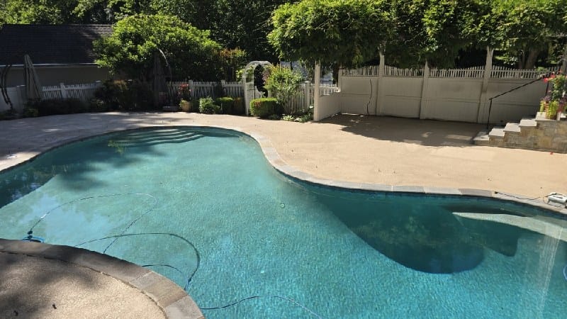 Stone pool deck with curved edge from a Rose job in Great Falls, VA
