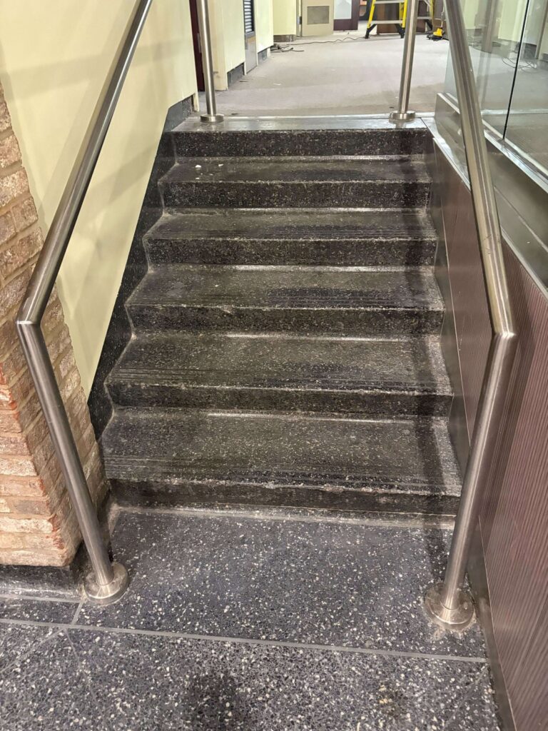 Stone staircase with metal railings at a federal research campus, Rose Restoration project