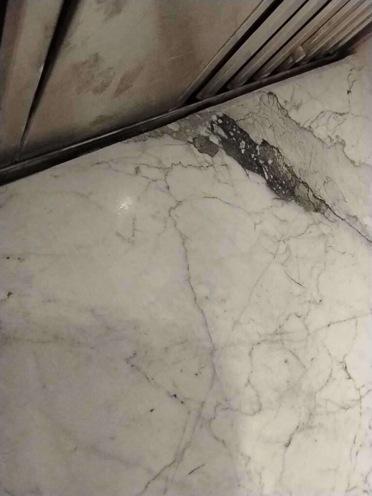 Stone surface with a crack and discoloration, Rose Restoration project
