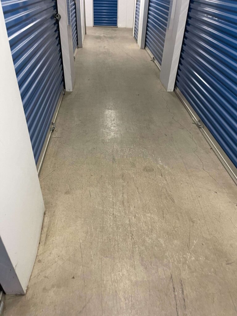Before: concrete corridor in a storage facility in Dumfries, VA, photographed by Rose Restoration before the work