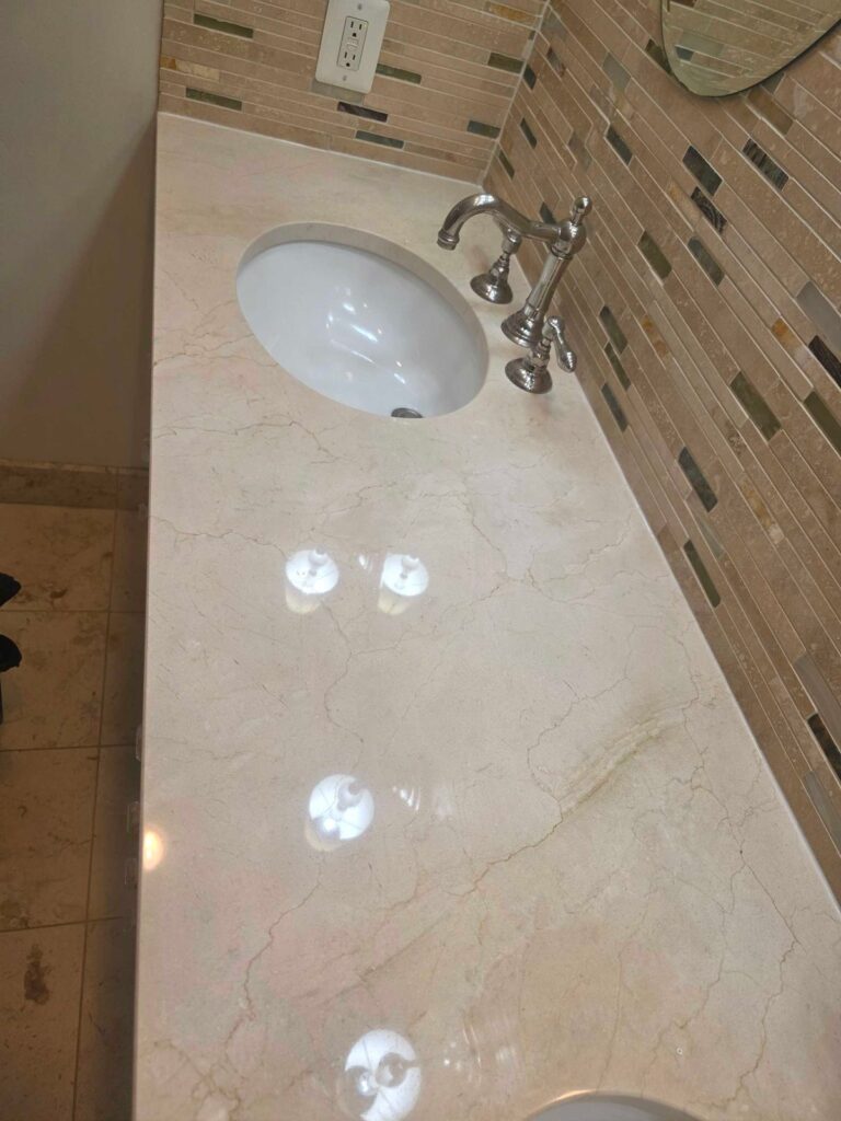After: the same travertine vanity top in Fairfax, VA after Rose Restoration's work