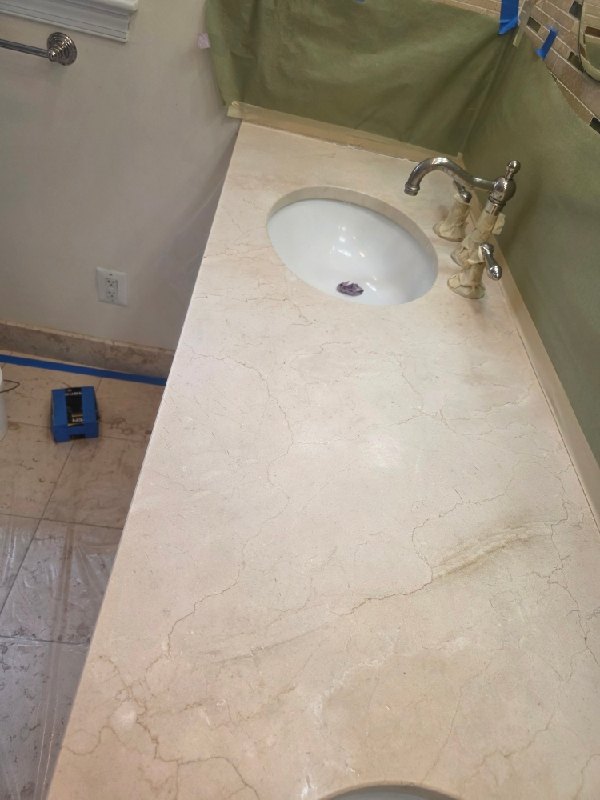 Before: travertine vanity top in Fairfax, VA, photographed by Rose Restoration before the work