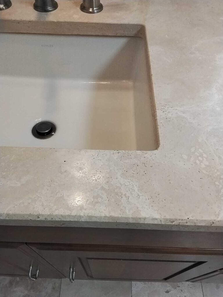 After: the same travertine vanity top in Oakton, VA after Rose Restoration's work