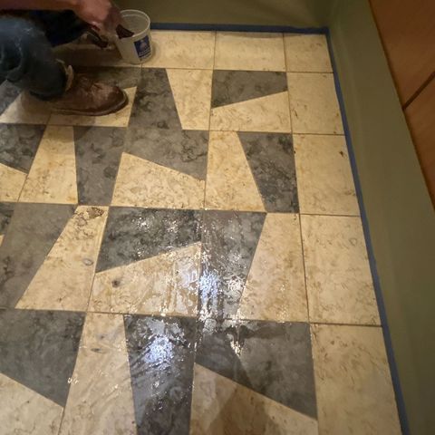 Stone floor in an elevator cab before restoration