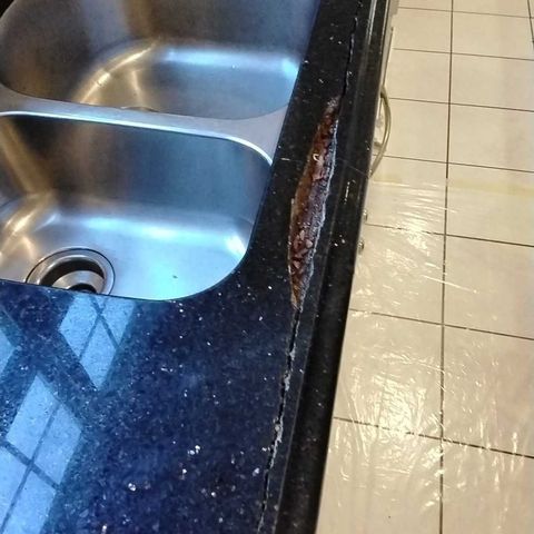 Cracked granite at a kitchen sink before restoration