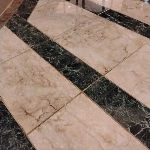 Inlaid stone atrium floor before restoration
