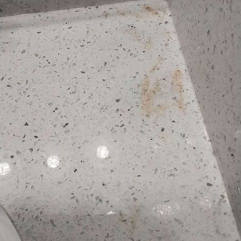 Quartz countertop rust stain before restoration